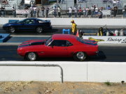 RED 1969 CAMARO WITH BLACK STRIPES